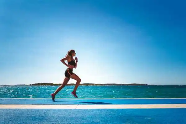 Woman running showing strong leg muscle Sutton Coldfield